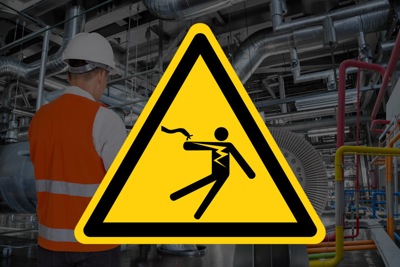 yellow electrical safety hazard sign on industrial background